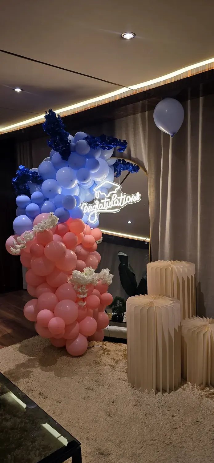 Navy and coral balloon column with silver foil accents and pleated stands
